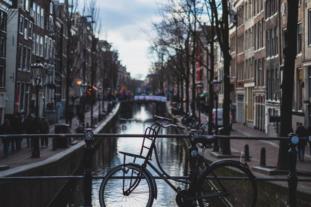 A classic bike on a bridge over an Amsterdam canal, capturing the citys charm.